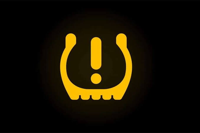 Amber tyre pressure (TPMS) warning light on a car dashboard